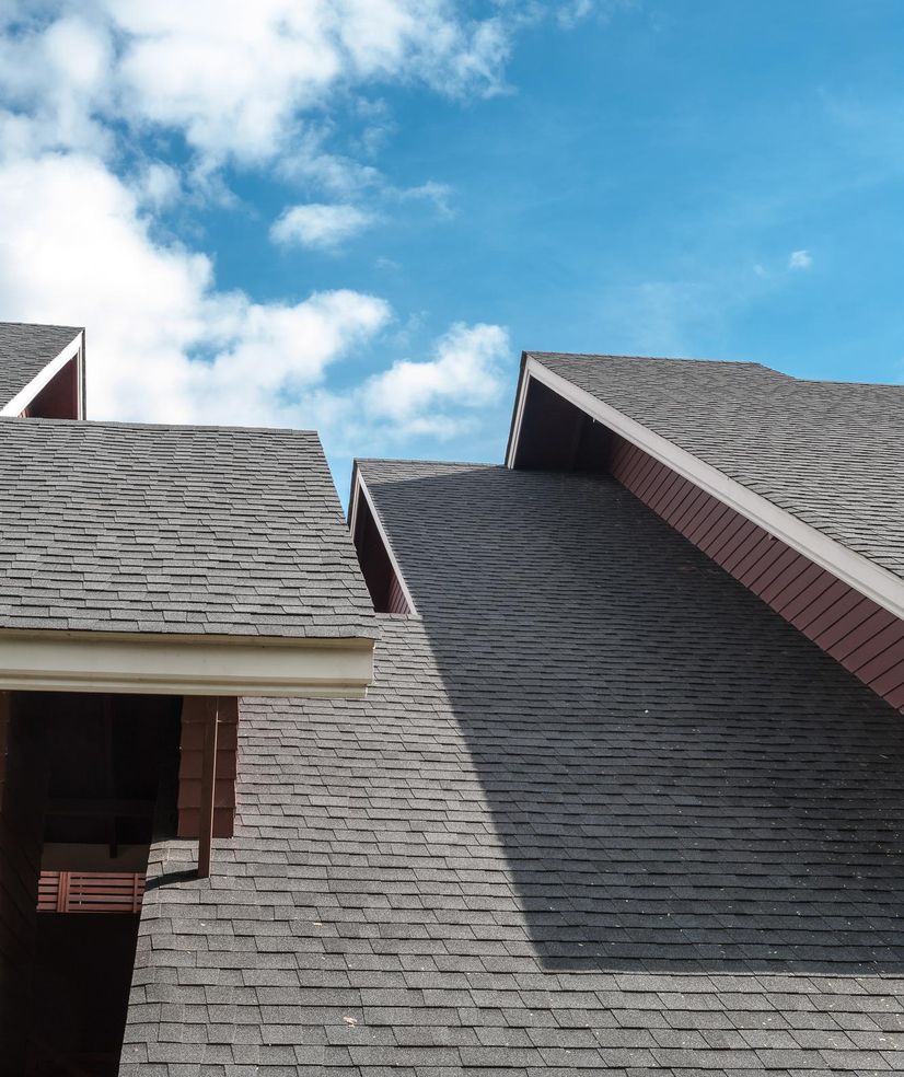 2 men working on repairing a roof