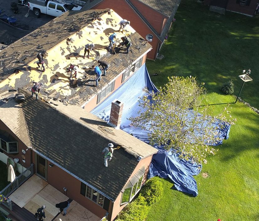 roofing contractors repairing a roof